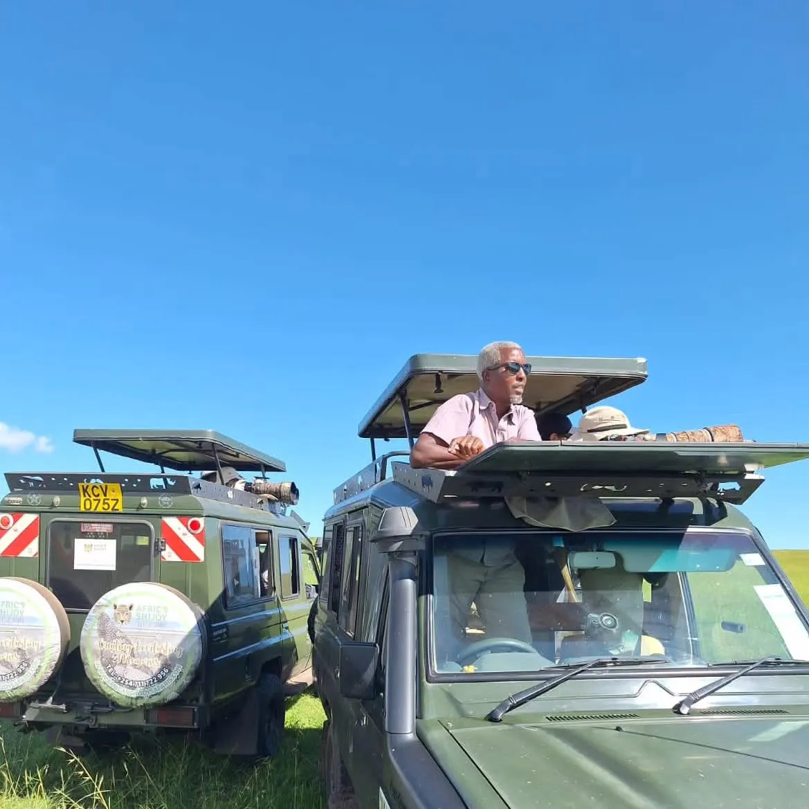 Joseph Mbotte guiding from the roof hatch of a safari vehicle